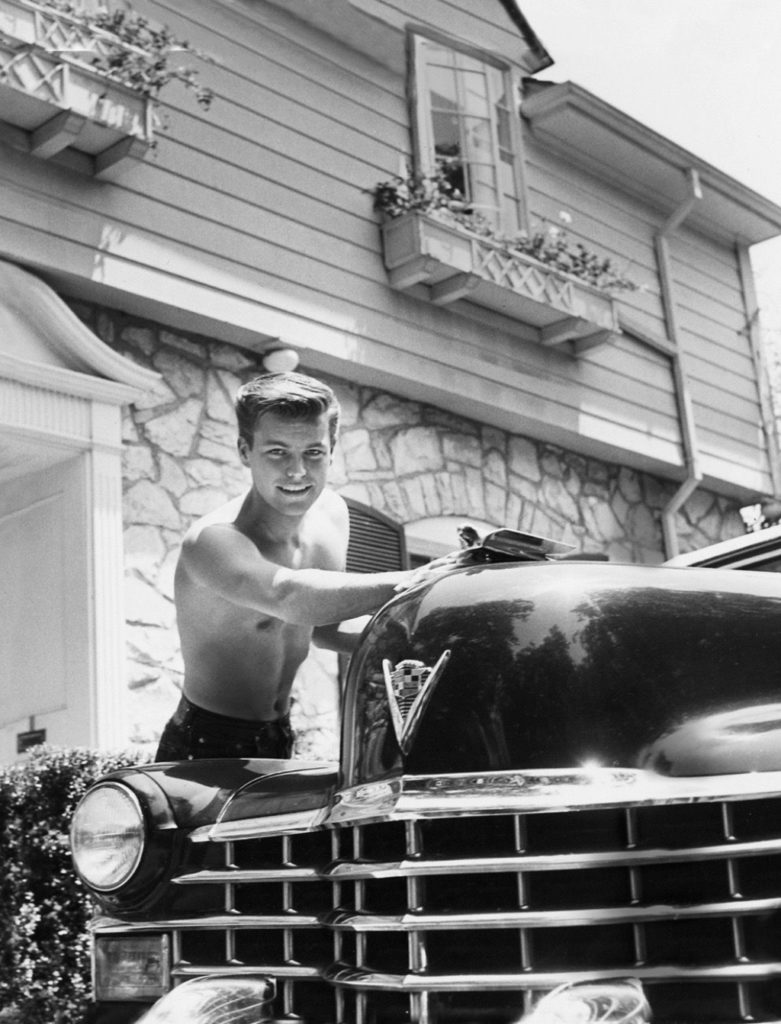 Robert Wagner dando brillo a su Cadillac descapotable de 1947